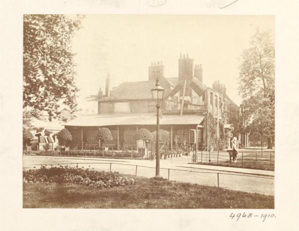 View of Brompton Park House with transportation vans parked under the lean to at side of building