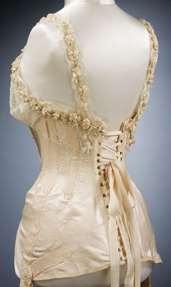 Corset for the wedding of Mrs G.E. Dixon in July 1905, satin trimmed in artificial orange blossom. © Victoria and Albert Museum, London Corset for the wedding of Mrs G.E. Dixon in July 1905, satin trimmed in artificial orange blossom. © Victoria and Albert Museum, London