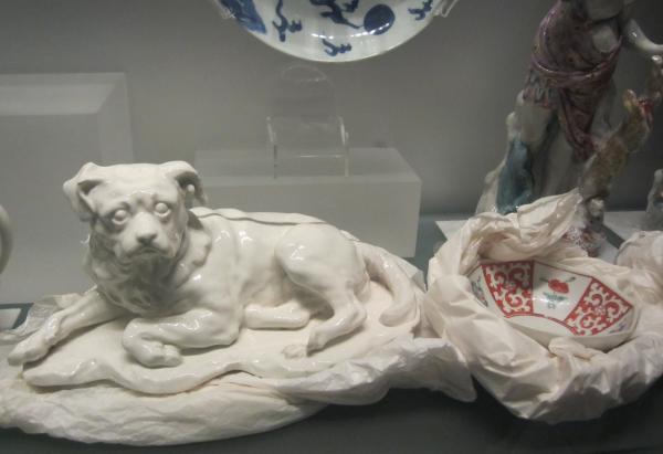 Whilst he has been made comfortable in a paper ‘basket’ this porcelain figure of Hogarth's dog 'Trump' (V&A C.101-1966) still seems a bit nonplussed at the empty bowl alongside him © Victoria and Albert Museum, London