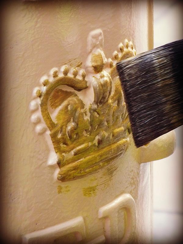 Letter box being painted gold