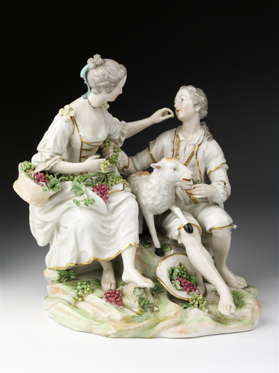 Figure group in soft-paste porcelain, painted with enamels and gilded, of a male youth and a girl offering each other grapes, made by William Duesbury & Co., Derby, ca. 1775. The grouping was adapted from an engraving by Jacques Phillipe Le Bas, after a painting by Boucher entitled 'Pensent-ils au raisin?' V&A 414:423-1885