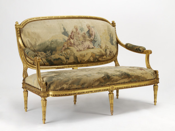 Giltwood settee, French, in Louis XVI style, 1870-1900, upholstered with Beauvais tapestry ca. 1760-733 V&A 465-1895 The scenes on both woollen tapestry panels are pastoral, with lovers with a birdcage (La pipeé aux oiseaux or 'the bird-catcher on the back and a scene of a peasant moving a barrel on a barrow on the seat (Le brouetteur or 'The barrow-man'/. These are scenes from the series Les Beaux Pastorales or La Noble Pastorale , a six-piece tapestry series woven fifteen times between 1755 and 1778. It was designed by François Boucher (1703-70) for the Beauvais manufactory.