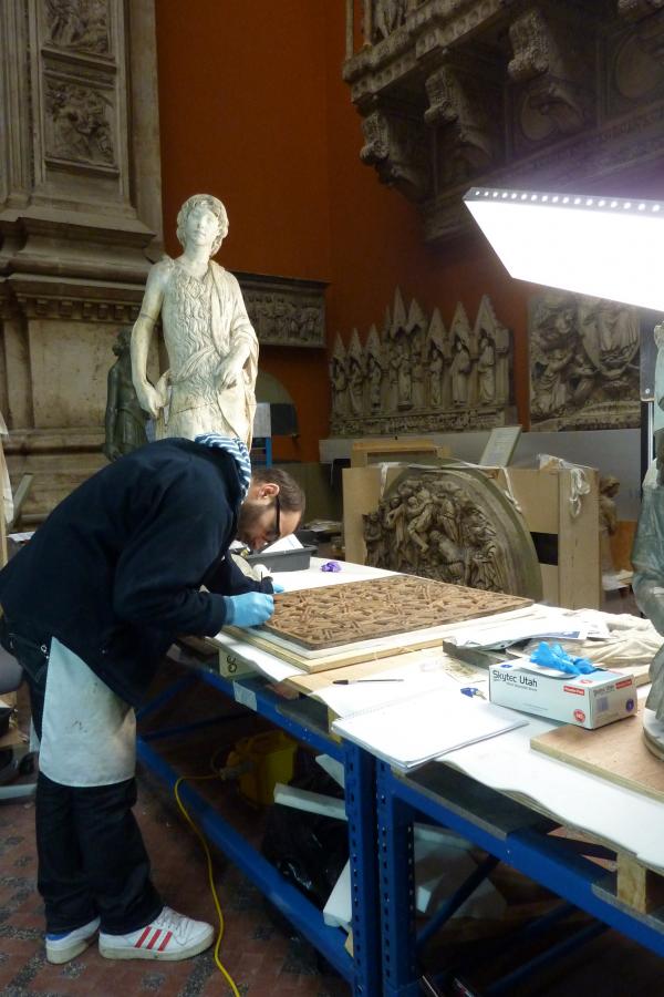 Conservator Sergio Merida working on the panel