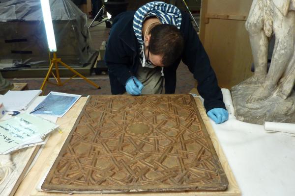 Conservator Sergio Merida working on the panel