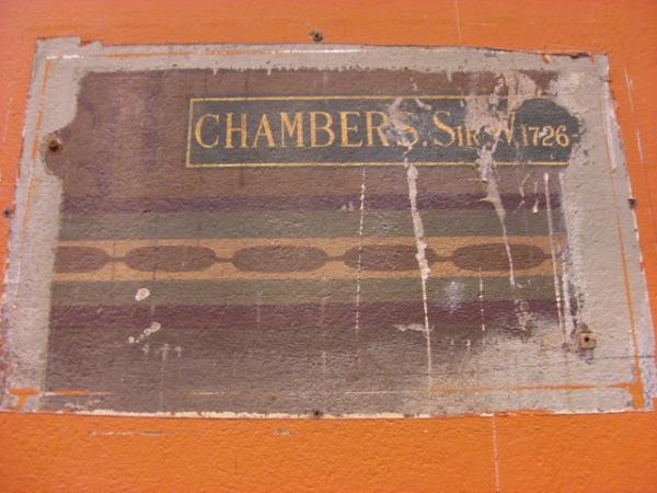 Original painted panel of architect's name revealed