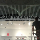 Workman installing Club to Catwalk sign