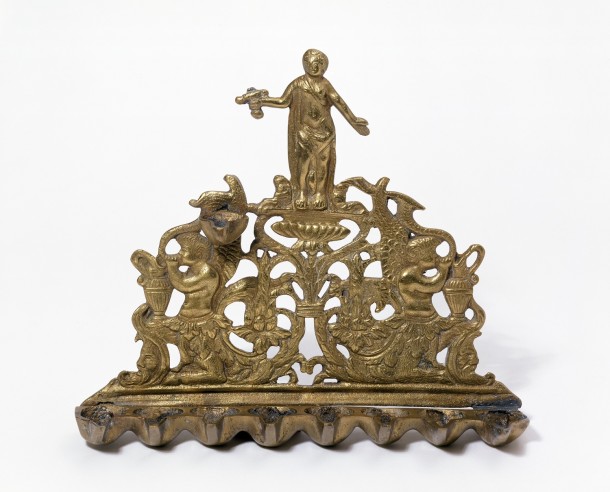 Hanukkah Lamp; brass. Height 20 cm. Bequeathed by Miss Estella Canziani Museum no. M.28-1965