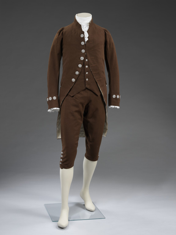 Man's suit of coat, waistcoat and breeches, dark brown wool, lined with silk and linen, with cut steel buttons. French, ca.1780. V&A T.10:1to3-2010