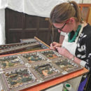Furniture conservator Dana Melchar retouching a resin restoration