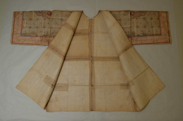 Reverse of shirt showing old stitched repairs to support areas of damage