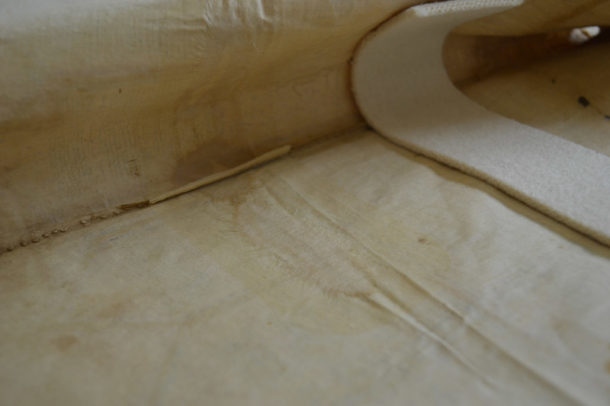 Reverse view of shirt showing crepeline adhesive film with paper patches on top