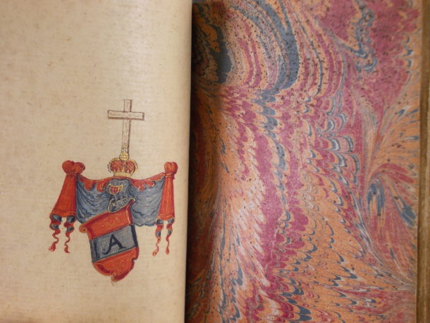 Inside the album. A coat of arms and a page of marbled paper.
