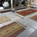 The author examining carpets in store at Blythe House