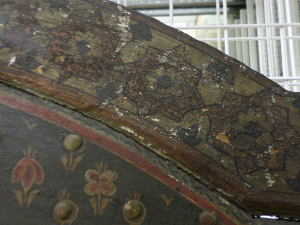 The wood of an internal panel has shrunk away from the framework. You can also see how the decoration is flaking © Victoria and Albert Museum London