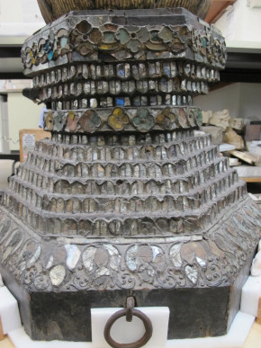 A view of the base from the front with remains of gilding present on the thayo reliefs