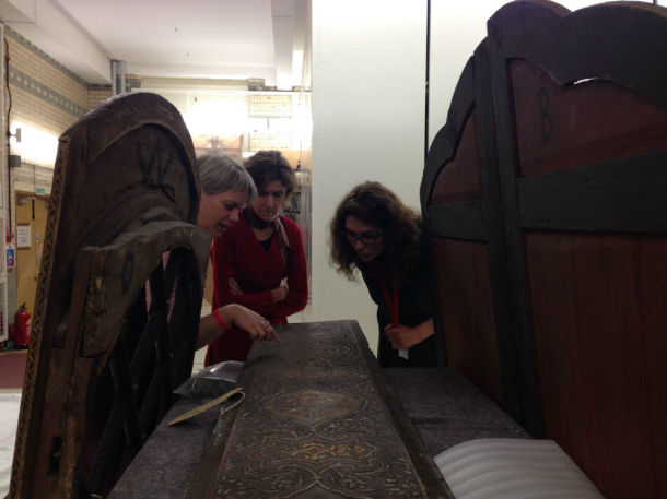 Anke Scharrahs (left) assessing the wooden panels with V&A conservators Vicky Oakley (centre) and Charlotte Hubbard (right) © Mariam Rosser-Owen