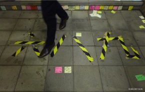 The tape on the floor at Lennon Wall’s staircase reads “689” in Chinese, a nickname of the city’s Chief Executive CY Leung. Leung won the Chief Executive election in 2012 with 689 votes from the 1,200 member election committee.©Becky Sun