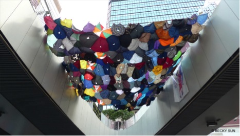 Installation from Baptist University students made from umbrella fabric hanging across footbridges leading to the Central Government Offices, above the self study area in Admiralty. ©Becky Sun.