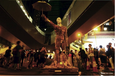 Umbrella Man sculpture in Admiralty by Milk, who was inspired by a photo of a protester shielding a police officer from the rain with his own umbrella. ©Becky Sun.