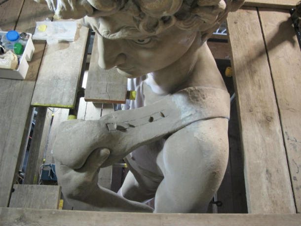 A rather grumpy looking David being partially dusted and surrounded by my tools and equipment. Notice the fixings on top of the sling