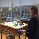 Florence pushing a trolley of objects through the gallery