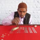 Meharban Khan doing gota work in the workshop on his roof