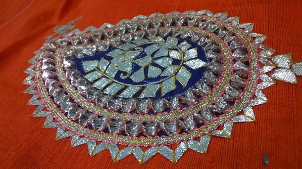 Gota work produced by Sankalan using folded silver ribbon to add three dimensionality to the design.