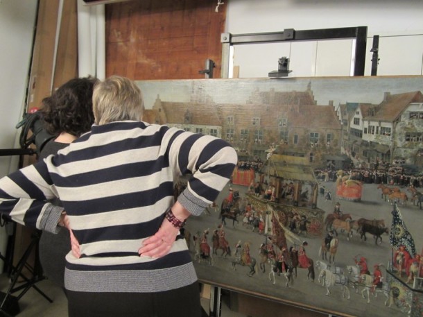 One of the Curators and Assistant Educator discussing which detail shots should be taken of the rather large and busy 'Ommegang' painting. © Victoria and Albert Museum, London
