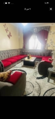 Large living room set with rug and curtains