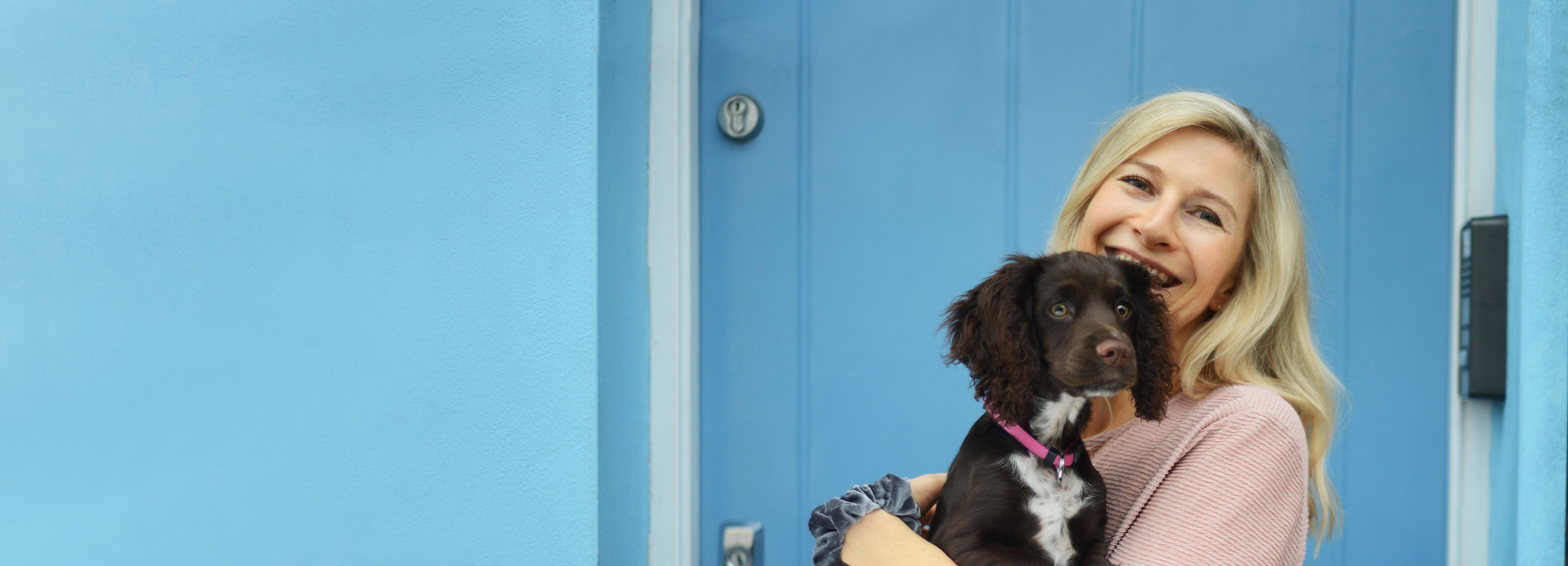 Young woman carrying insured dog