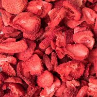 a white ceramic bowl with whole bright red pink strawberries, strawberry, freeze dried