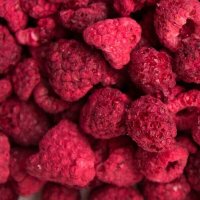 a metal spoon with whole raspberries spilling, raspberry, bright red pink violet