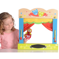 Child playing with wooden finger puppet theatre