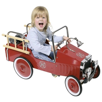 Child riding the pedal fire engine