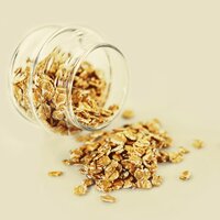 a spilled glass jar of oats, split, crunchy