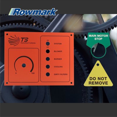Rowmark Safe-T-Mark plastic panel with engraved control labels and warning tags on industrial machinery.