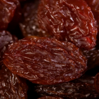 close up of bright red maroon sultanas, prune, dried fruit