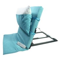 The Electric Backrest Straightener folded with a removable pillow and a blue suede covering.