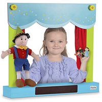 Child playing with wooden table-top carry-case puppet theatre and shop