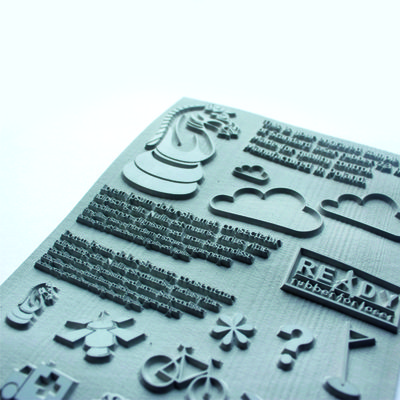 Laser-engraved rubber sheet displaying icons, text, and graphics