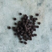 a pile of cocoa brownie pieces on a grey marbled table top