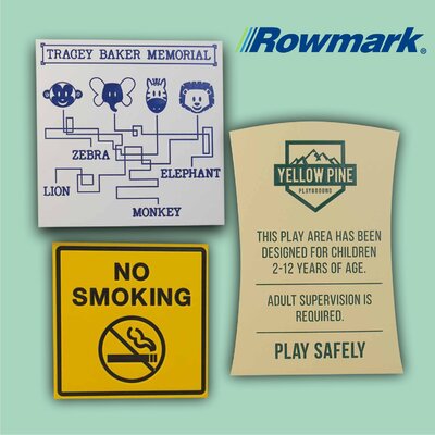 Engraved heavy-duty plastic signs in a zoo and playground setting, featuring bold safety and directional messages.