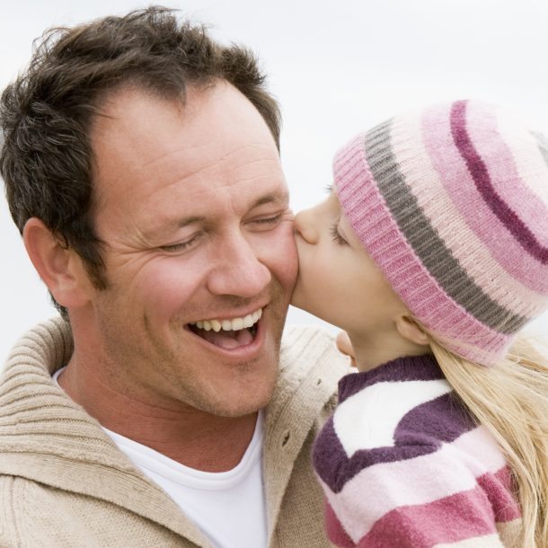 Daughter Kissing Dad On Cheek For Father's Day