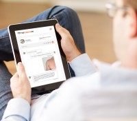 Man holding a digital tablet and reading news