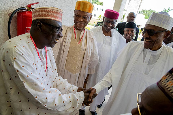 Buhari shaking Ahmed Makarfi