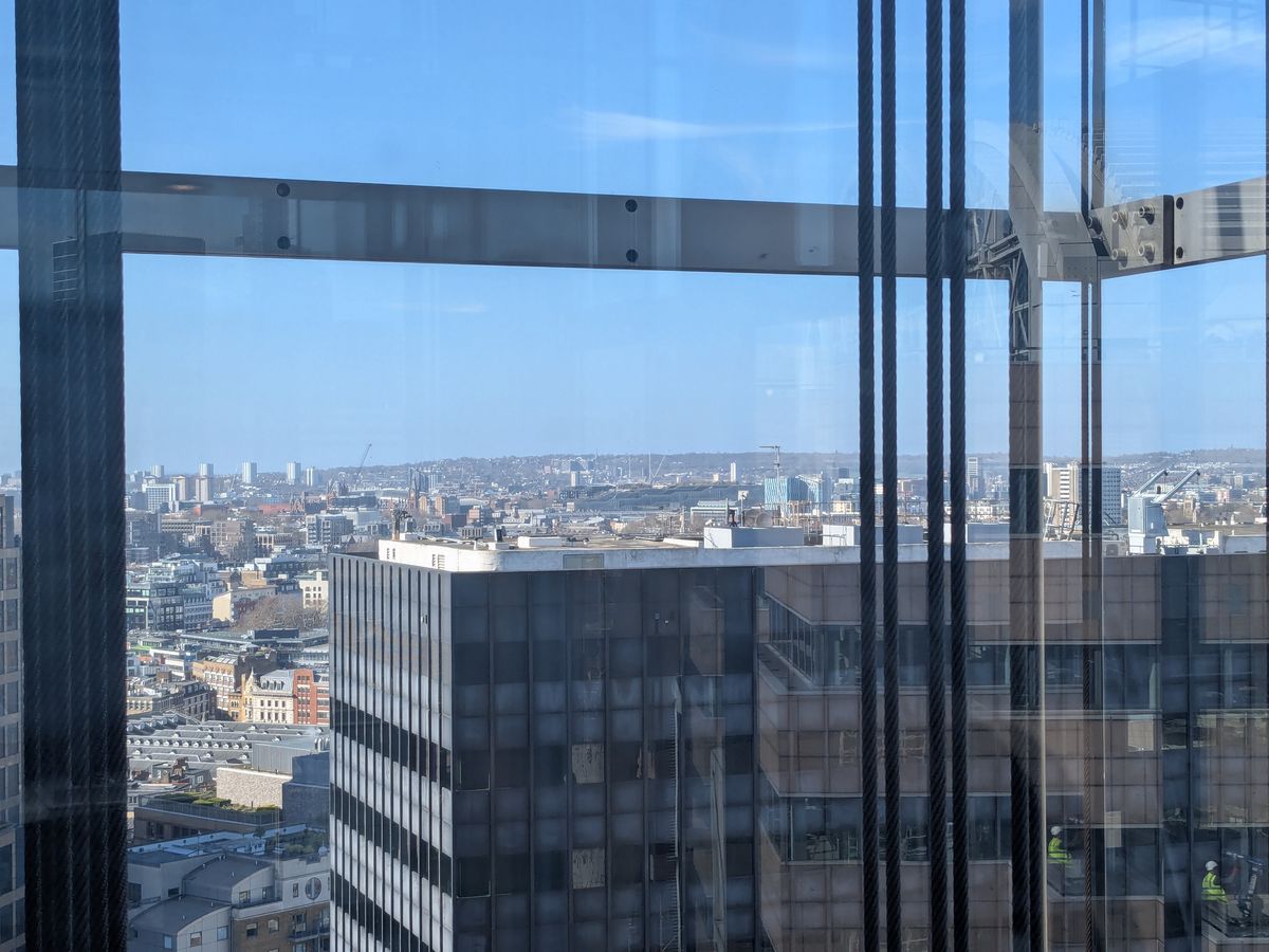London panorama through office window — the journey begins