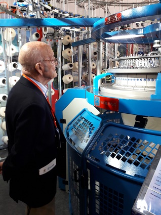 john stanier examining a knitting machine