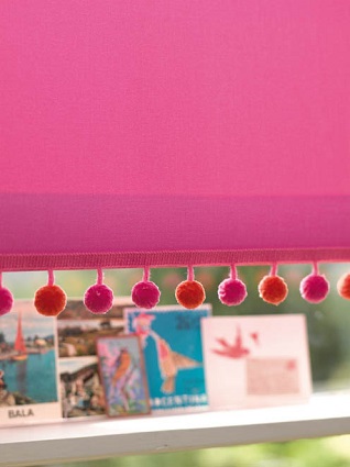 hot pink & tangerine pompom on a window blind