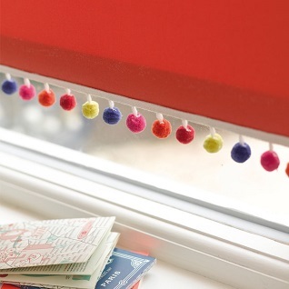 pompom braid on a red window blind
