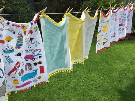 tea towels with pompom fringe on a washing line tea towels with pompom fringe on a washing line